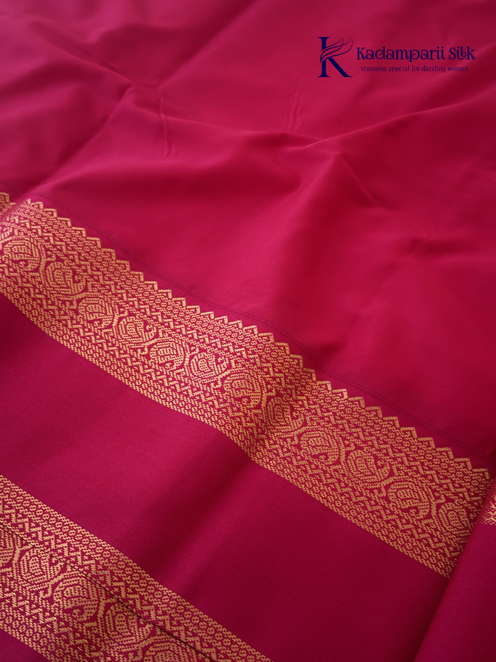 Off white art silk saree with rani pink zari border and traditional gold woven detailing displayed on white background