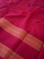 Off white art silk saree with rani pink zari border and traditional gold woven detailing displayed on white background