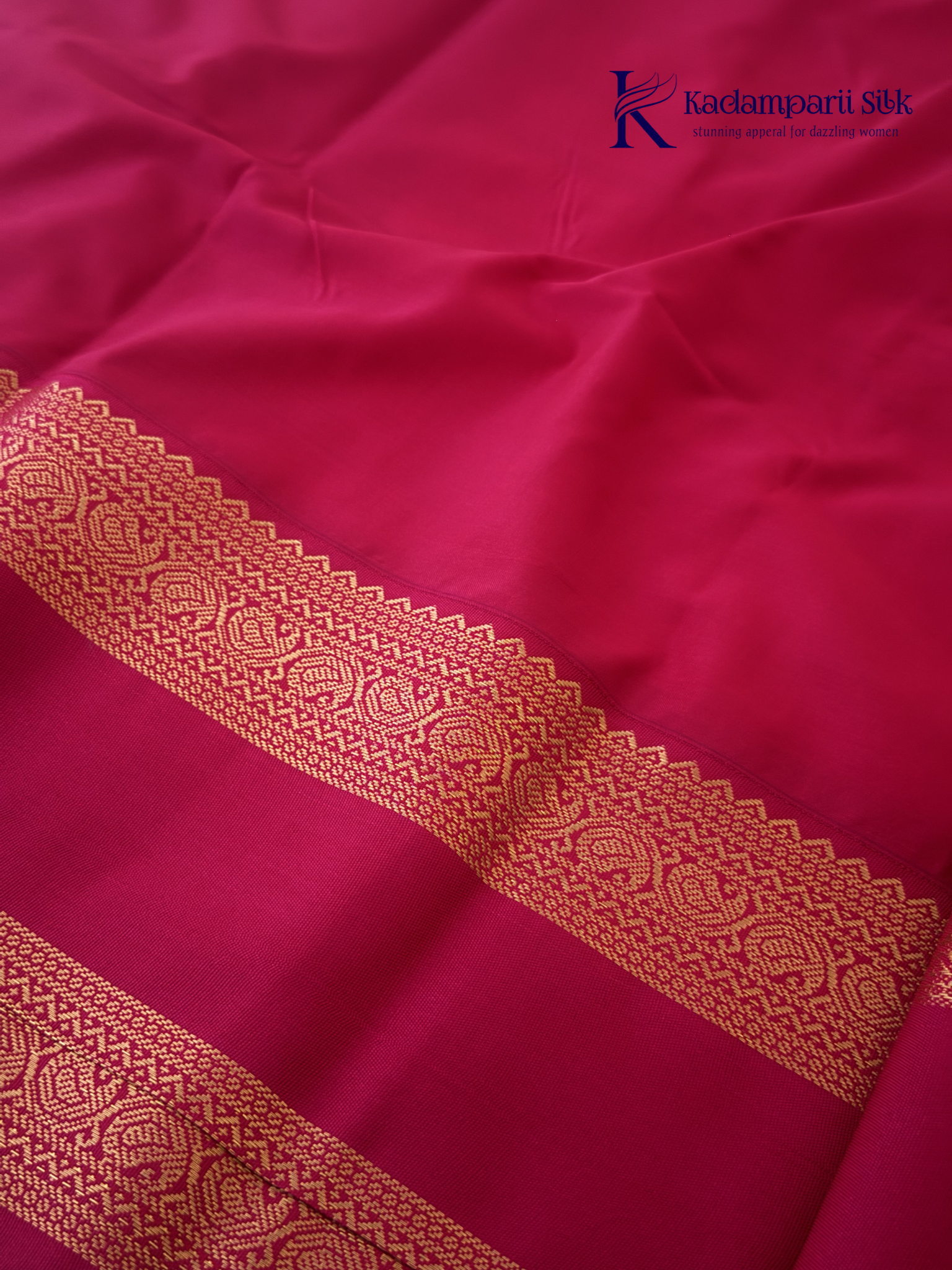 Off white art silk saree with rani pink zari border and traditional gold woven detailing displayed on white background