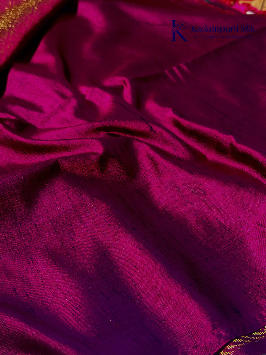 Kadamparii Silk emerald green jute mixed semi soft silk saree with magenta zari woven border, tassels, and gold zari motifs displayed on white background