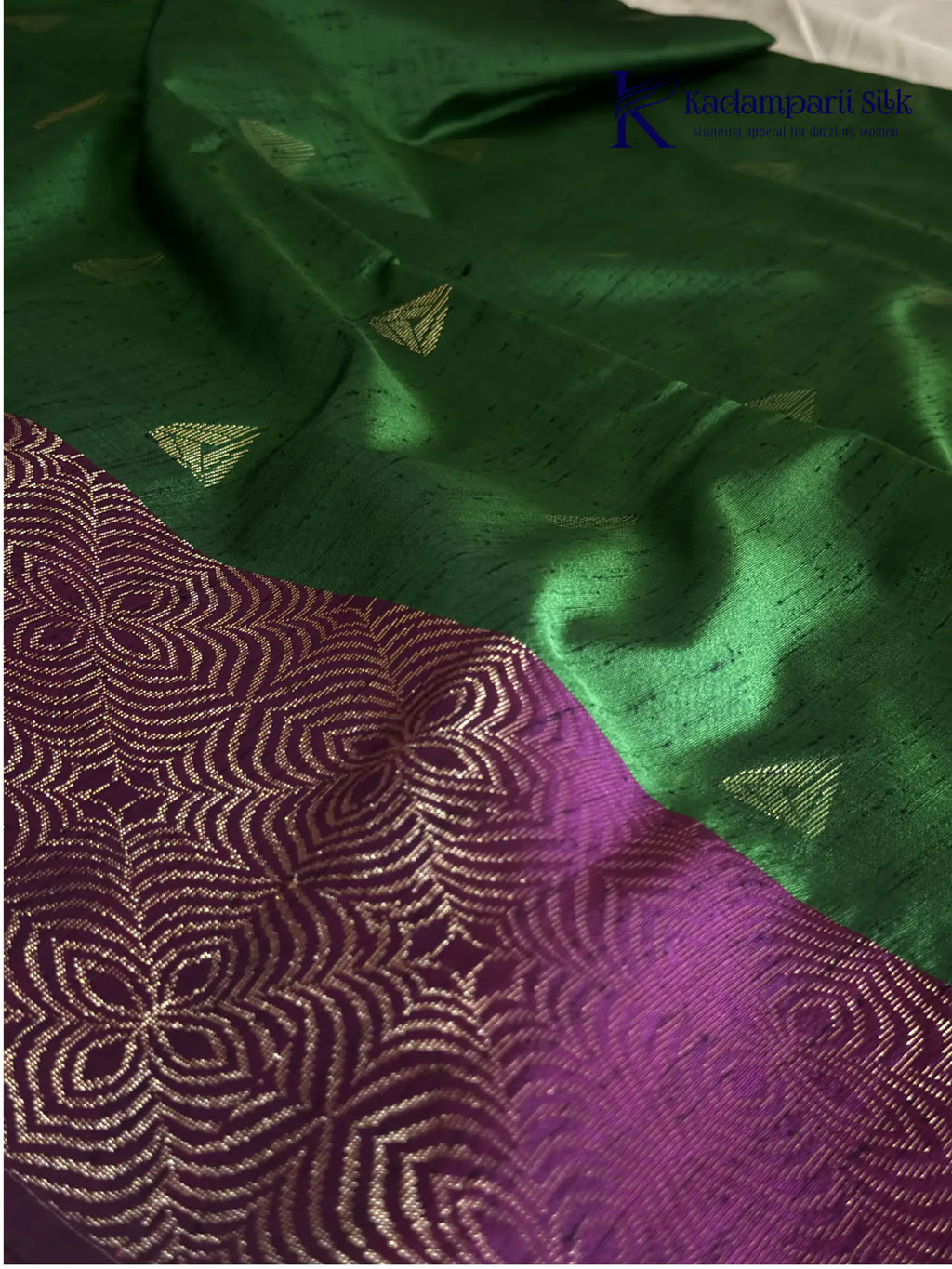 Kadamparii Silk emerald green jute mixed semi soft silk saree with magenta zari woven border, tassels, and gold zari motifs displayed on white background