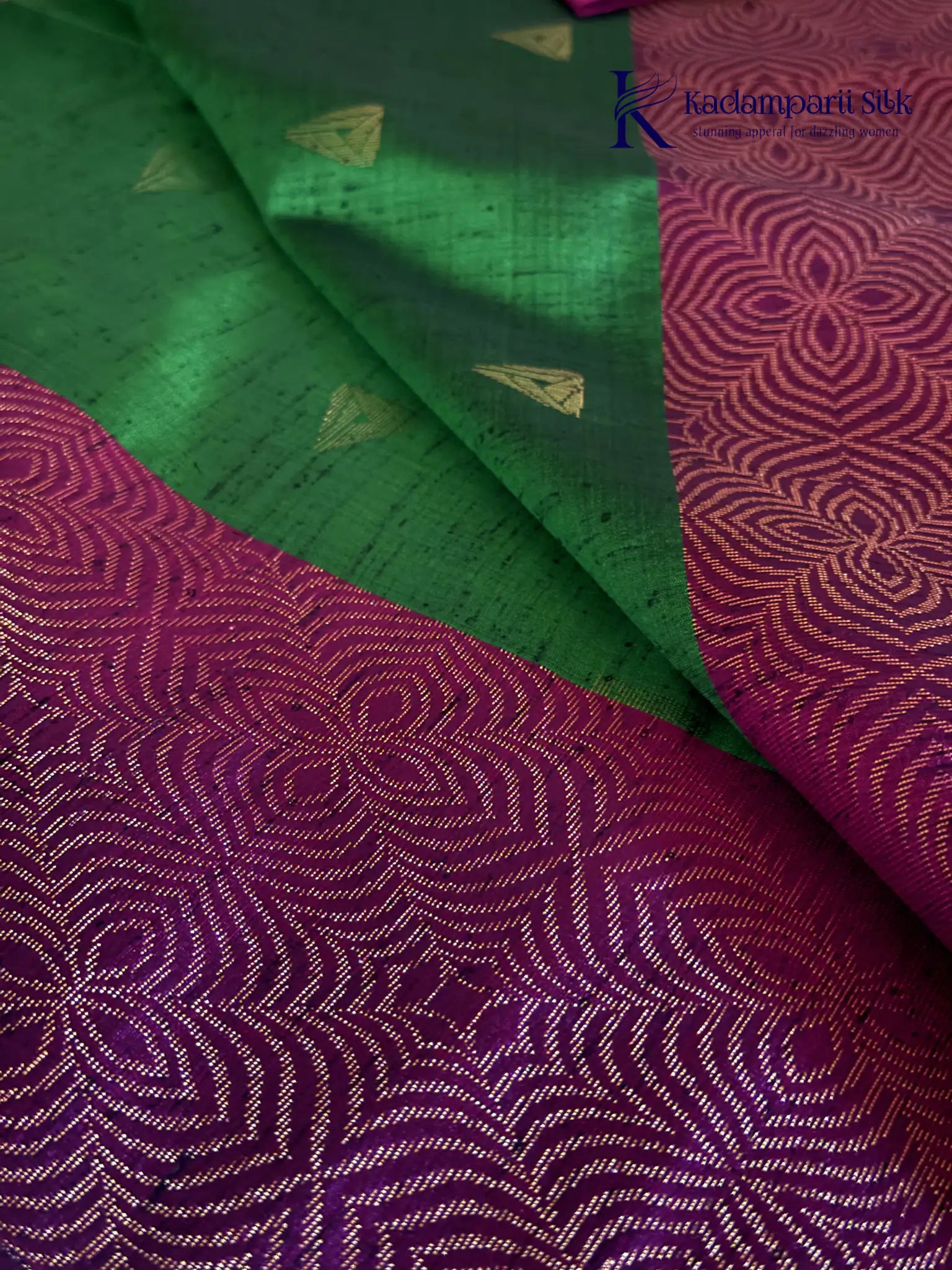 Kadamparii Silk emerald green jute mixed semi soft silk saree with magenta zari woven border, tassels, and gold zari motifs displayed on white background