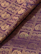 Chocolate brown art silk saree with ice blue zari woven border and traditional peacock motifs displayed on white background Kadamparii Silk