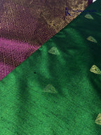 Kadamparii Silk emerald green jute mixed semi soft silk saree with magenta zari woven border, tassels, and gold zari motifs displayed on white background