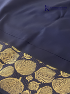 Mustard yellow art silk saree with navy blue floral zari border and textured weave displayed on white background Kadamparii SIlk