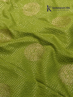 Lime green art silk saree with purple zari border and traditional woven detailing displayed on white background Kadamparii Silk