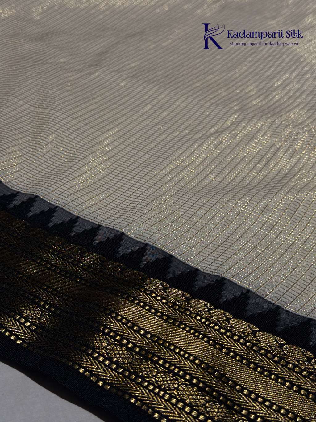 Kadamparii Silk ivory semi soft silk saree with black zari woven border and pallu, intricate traditional patterns, subtle checked texture, and tassel detailing.