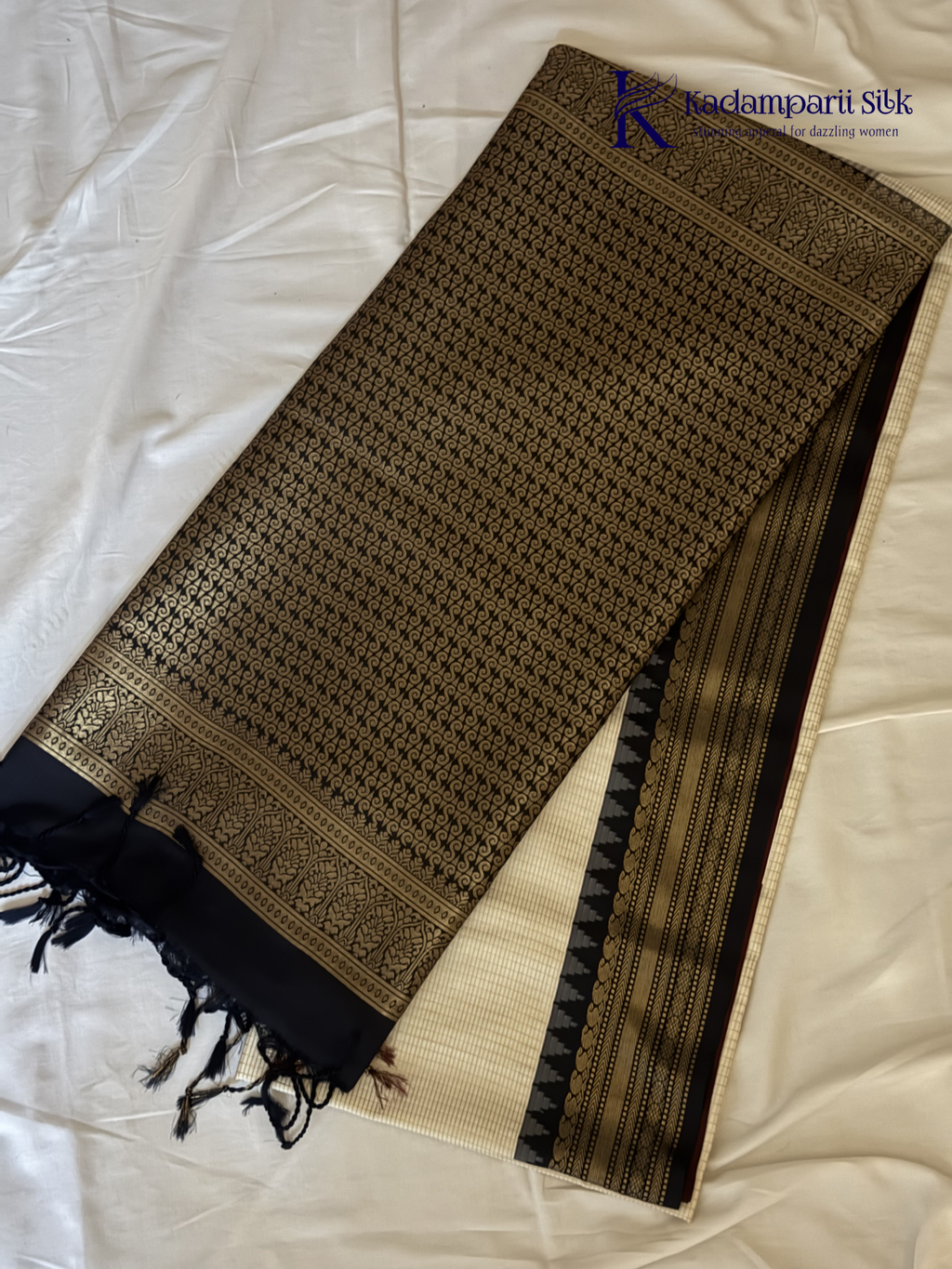 Kadamparii Silk ivory semi soft silk saree with black zari woven border and pallu, intricate traditional patterns, subtle checked texture, and tassel detailing.