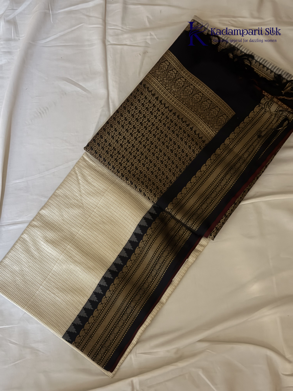 Kadamparii Silk ivory semi soft silk saree with black zari woven border and pallu, intricate traditional patterns, subtle checked texture, and tassel detailing.