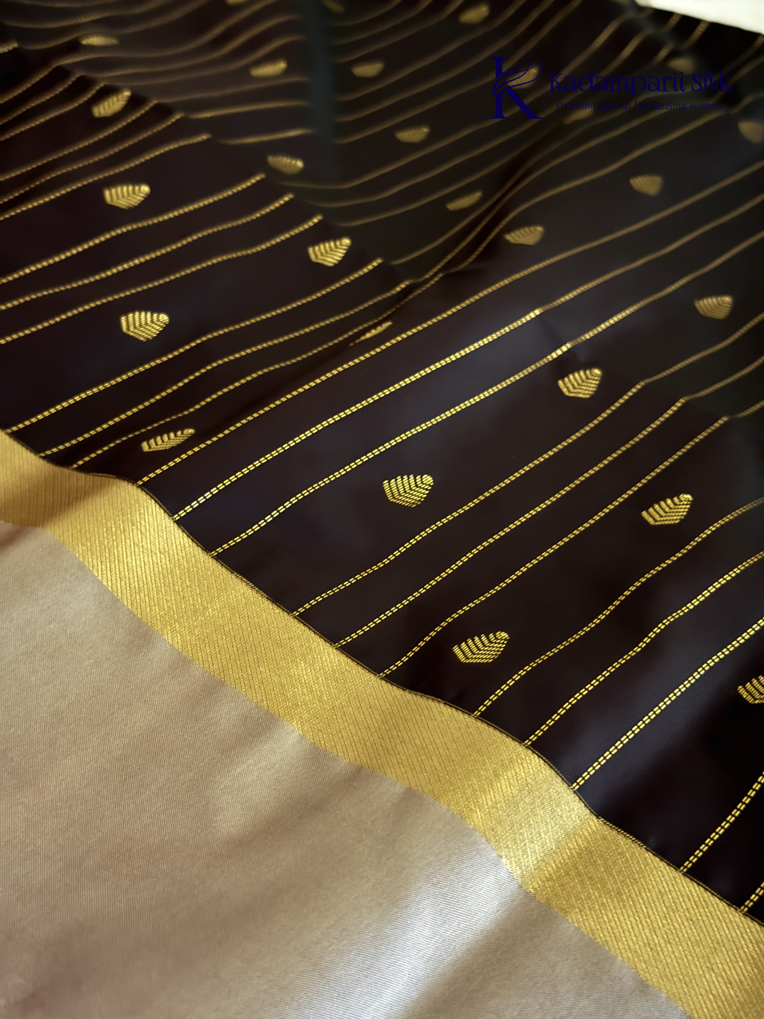Kadamparii Silk midnight black semi soft silk saree with silver zari woven pallu, striped body design, elegant border, and tassel detailing.