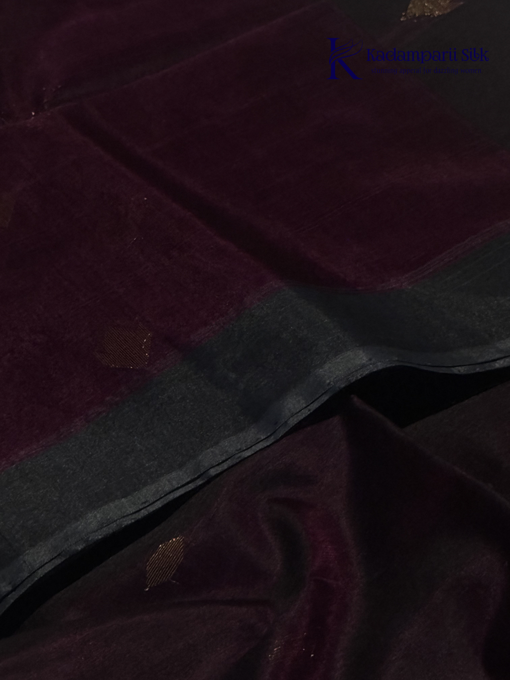 Wine silk cotton saree with black zari woven pallu and gold zari detailing displayed on white background