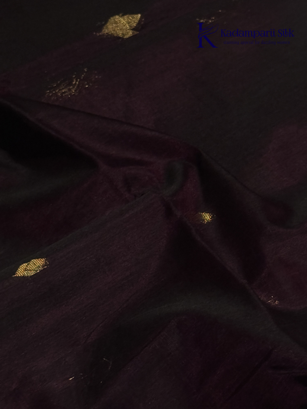 Wine silk cotton saree with black zari woven pallu and gold zari detailing displayed on white background