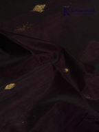 Wine silk cotton saree with black zari woven pallu and gold zari detailing displayed on white background