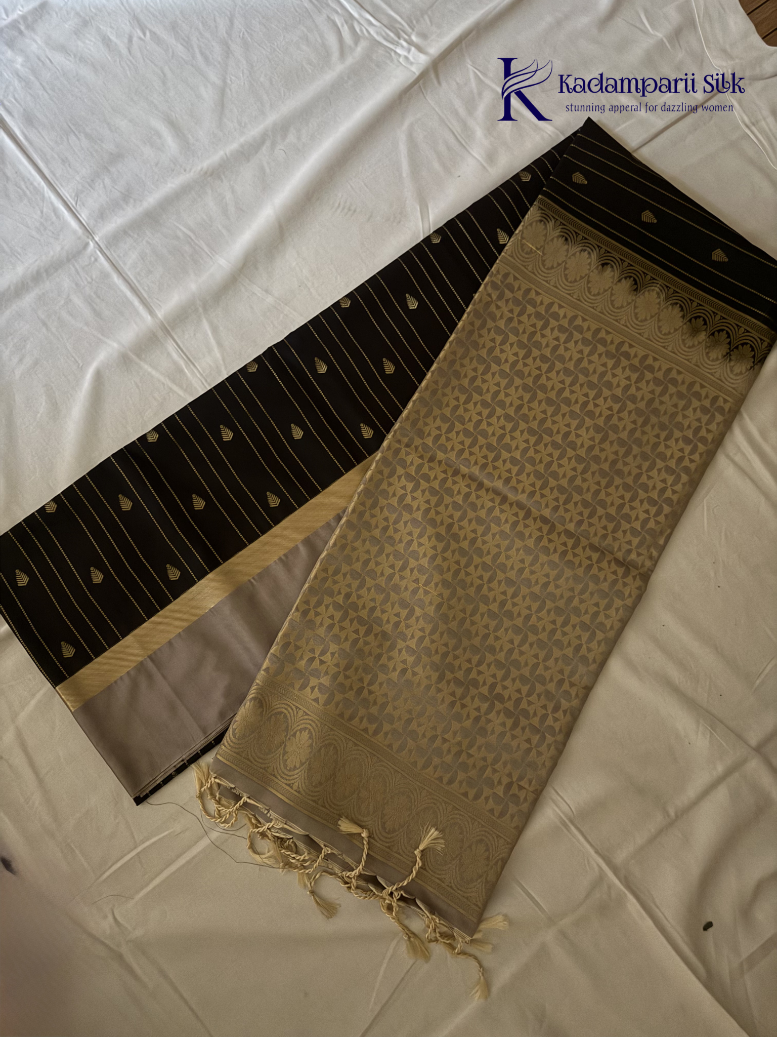 Kadamparii Silk midnight black semi soft silk saree with silver zari woven pallu, striped body design, elegant border, and tassel detailing.