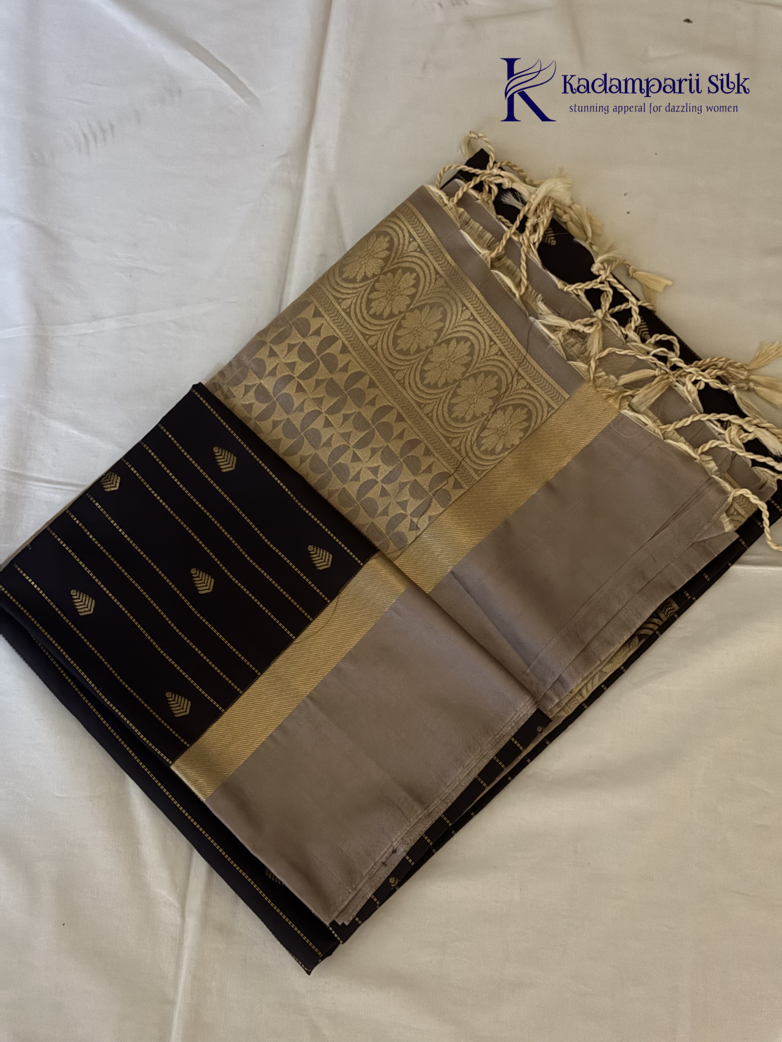 Kadamparii Silk midnight black semi soft silk saree with silver zari woven pallu, striped body design, elegant border, and tassel detailing.