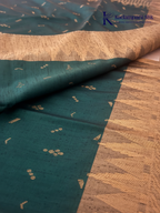 Kadamparii Silk teal green jute mixed semi soft silk saree with golden zari border, woven pallu, subtle motifs, and tassel detailing.
