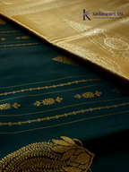 Kadamparii Silk royal navy blue semi soft silk saree with gold zari motifs, paisley design, grand zari woven pallu, and tassel detailing.