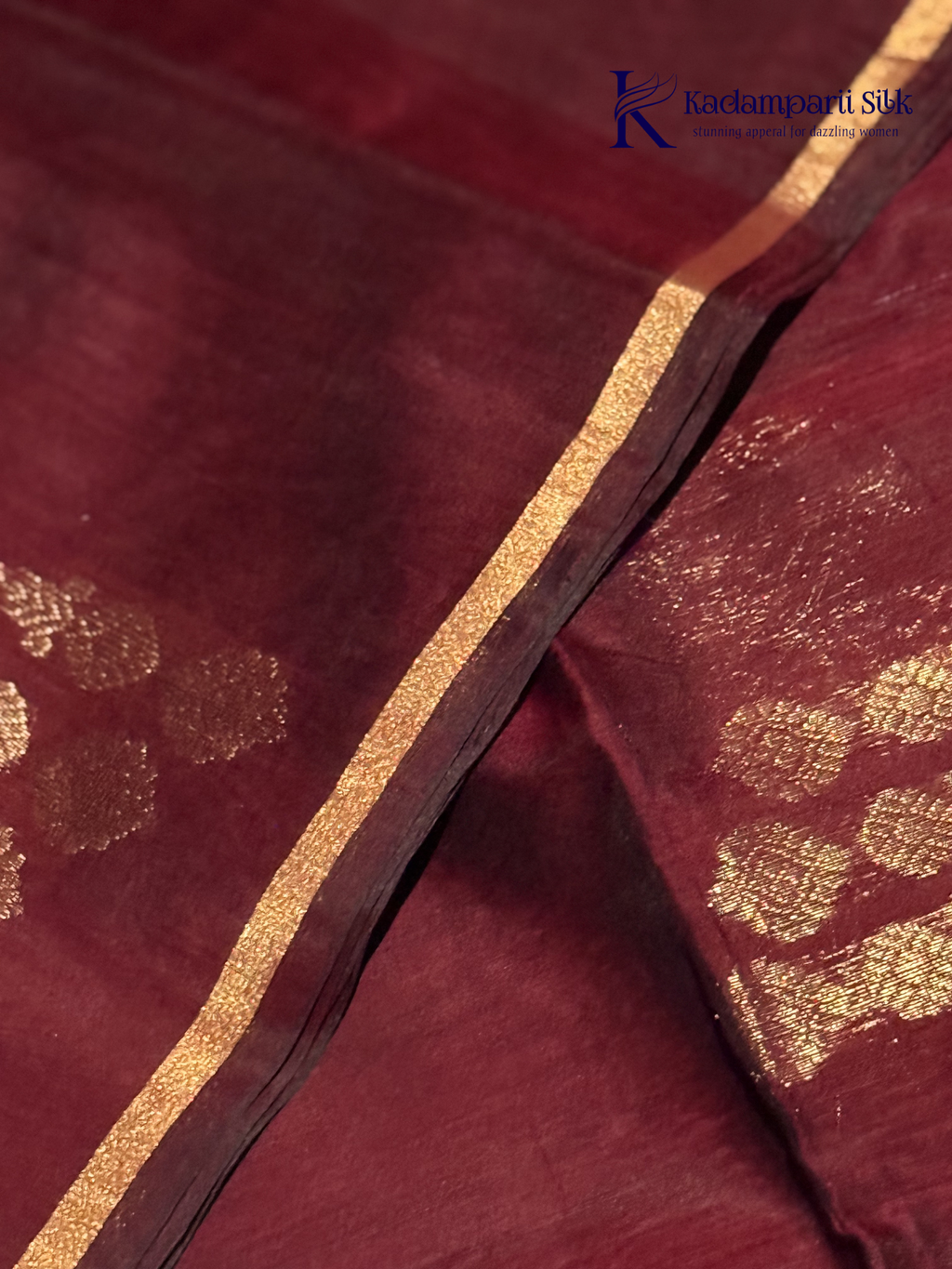 Close-up of maroon fabric with gold patterns Kadamparii Silk