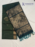 Green and black saree with intricate patterns on a white background, featuring the brand 'Kadamparii Silk'.Silk Cotton