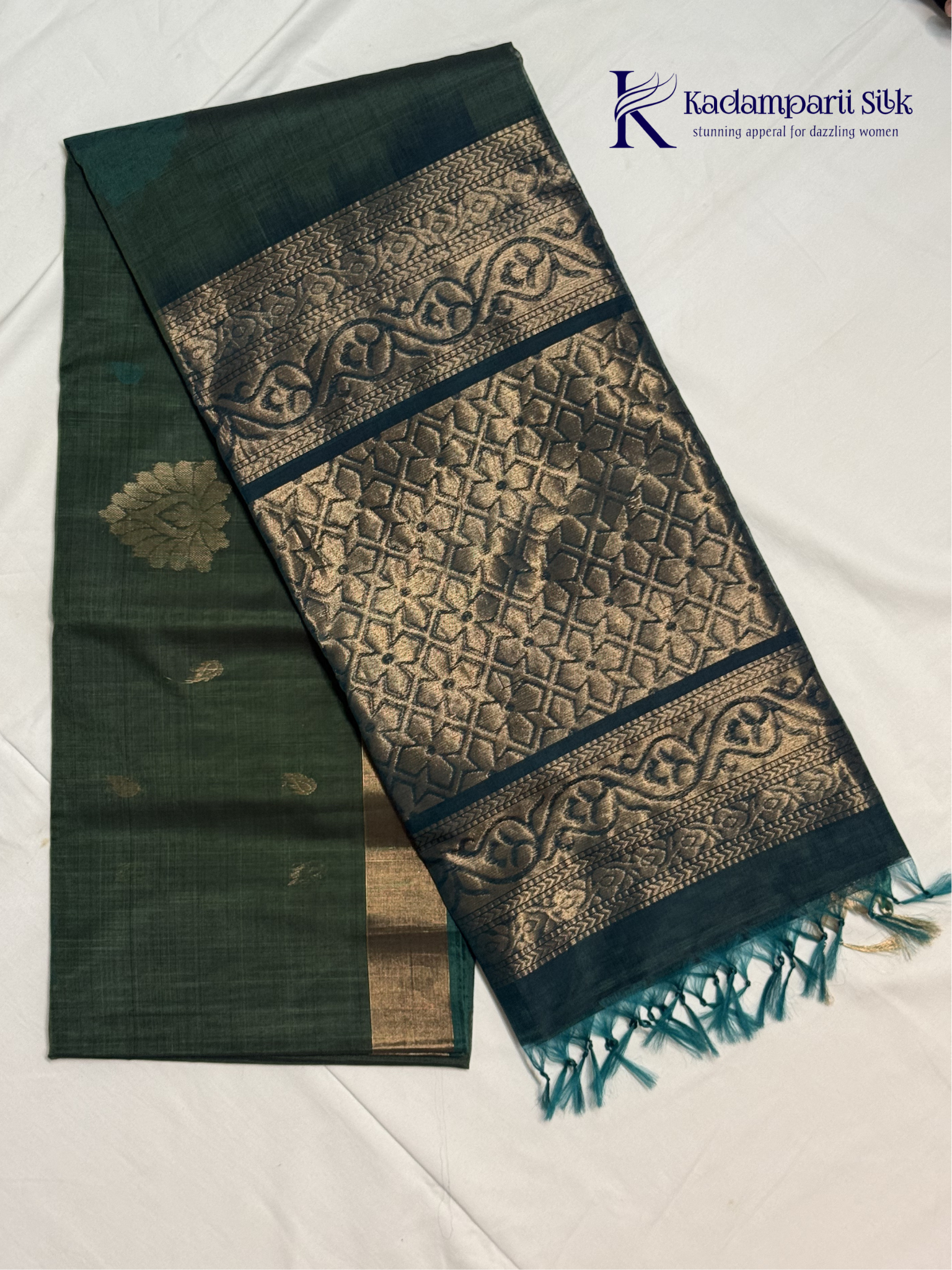 Green and black saree with intricate patterns on a white background, featuring the brand 'Kadamparii Silk'.Silk Cotton