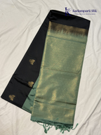 Kadamparii Silk black and sage green semi soft silk saree with gold zari buttas, intricate woven border, rich zari pallu, and tassel detailing.