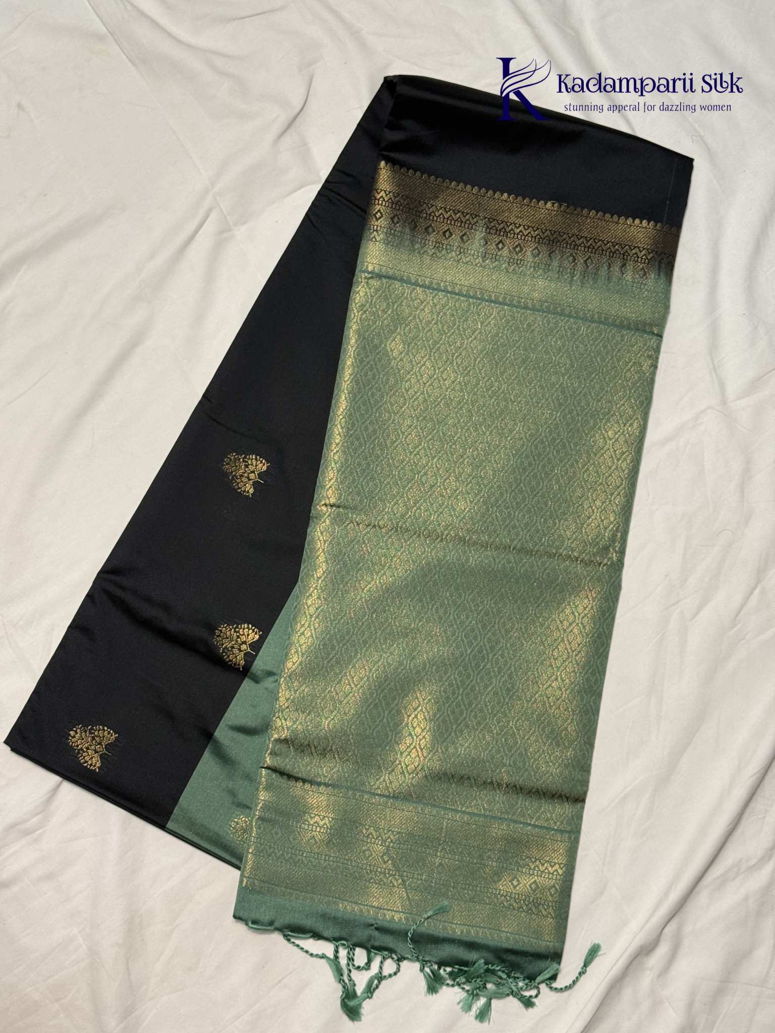 Kadamparii Silk black and sage green semi soft silk saree with gold zari buttas, intricate woven border, rich zari pallu, and tassel detailing.