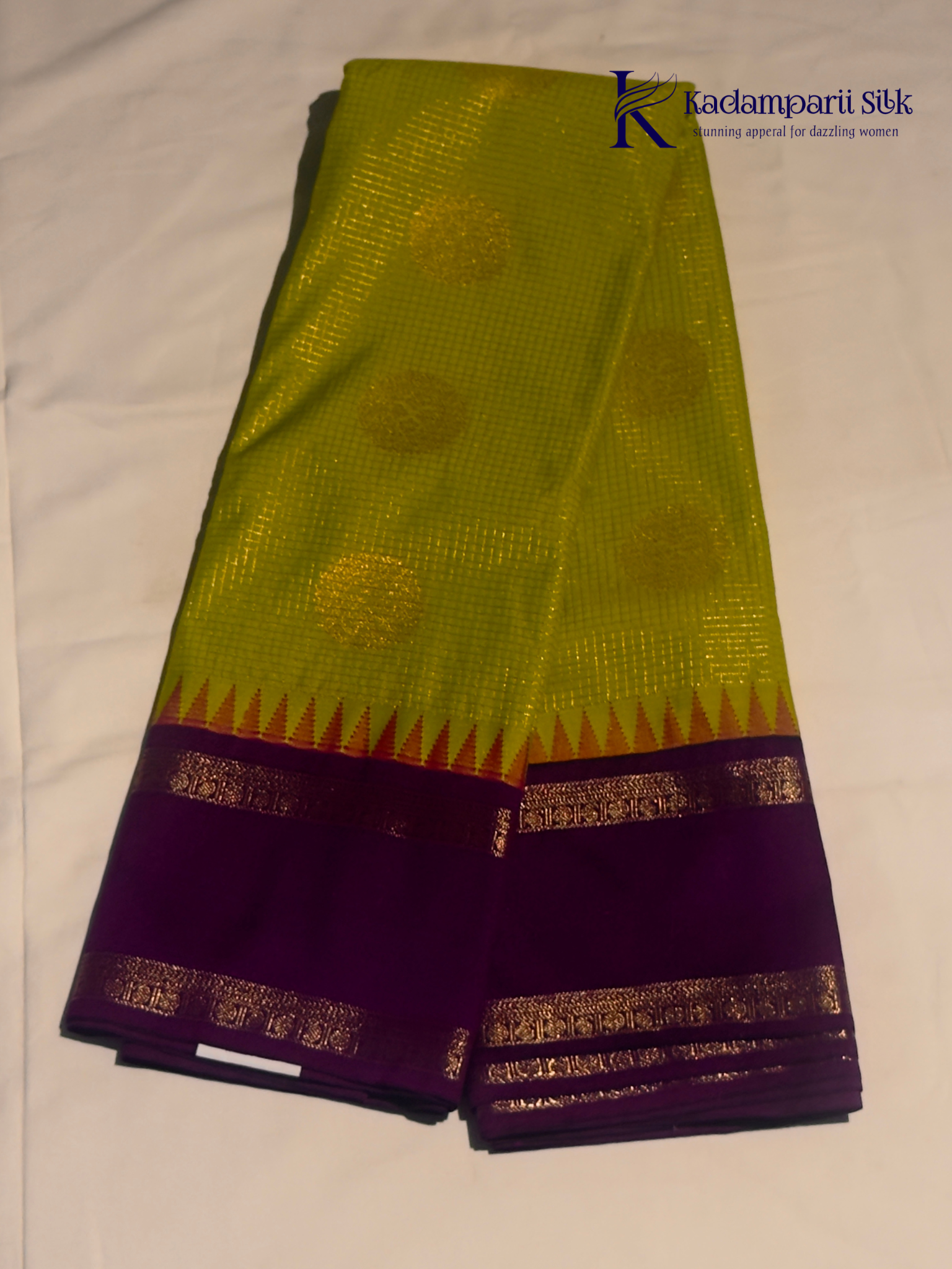 Lime green art silk saree with purple zari border and traditional woven detailing displayed on white background Kadamparii Silk