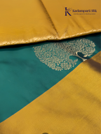 Kadamparii Silk emerald green semi soft silk saree with antique gold zari border, floral woven motifs, rich zari pallu, and elegant tassel detailing.