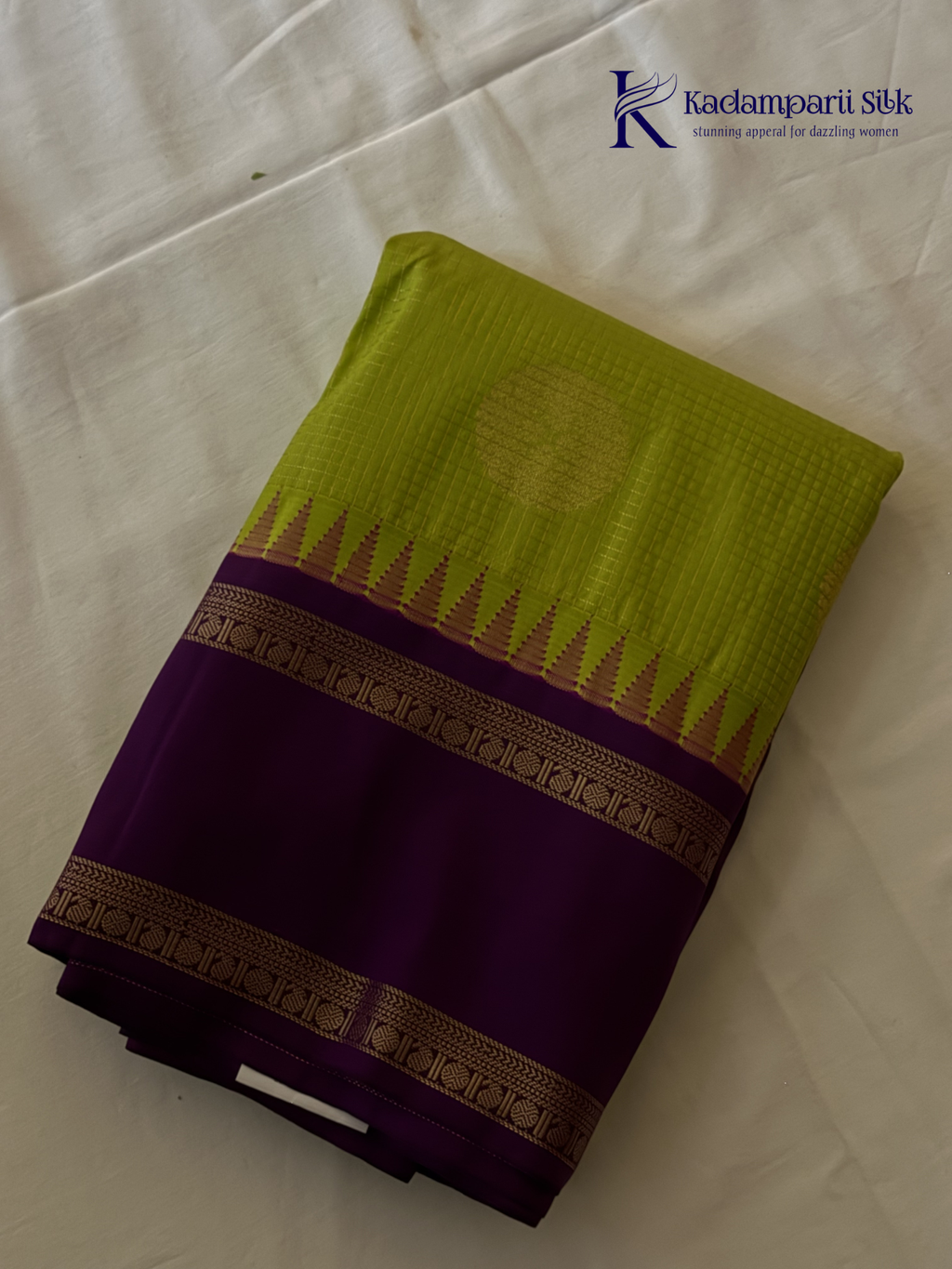 Lime green art silk saree with purple zari border and traditional woven detailing displayed on white background Kadamparii Silk