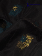 Black saree with gold and blue patterns on a white background, branded 'Kadamparii Silk'. Silk Cotton