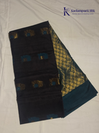 Black saree with gold and blue patterns on a white background, branded 'Kadamparii Silk'. Silk Cotton
