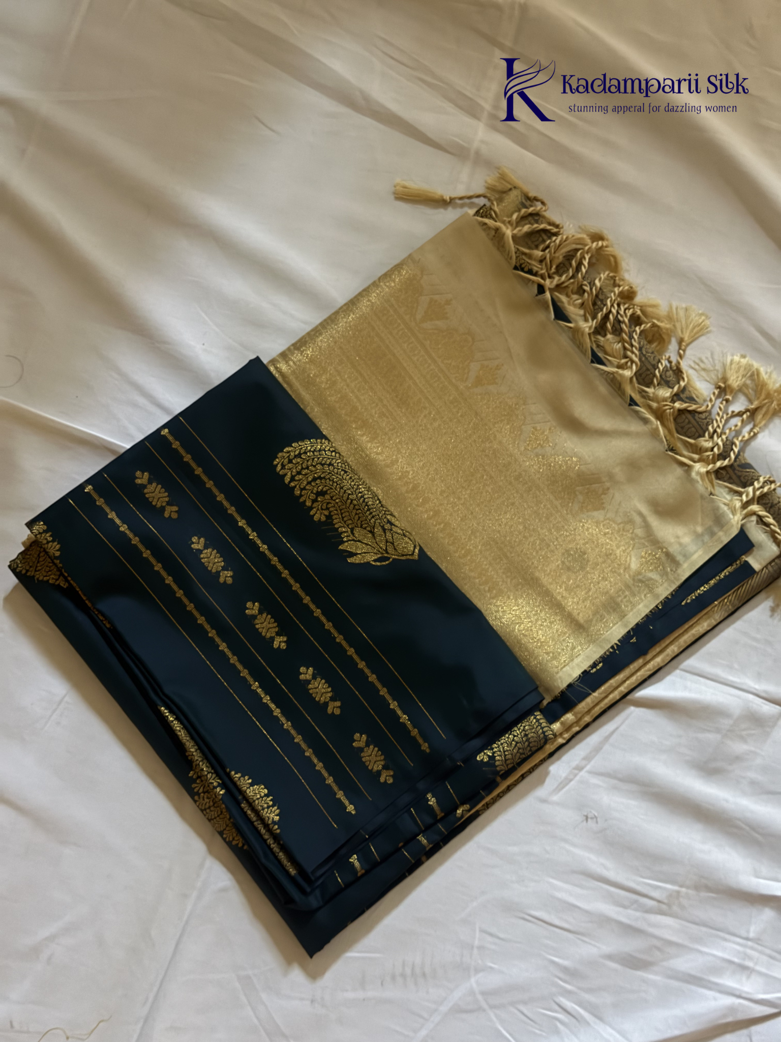 Kadamparii Silk royal navy blue semi soft silk saree with gold zari motifs, paisley design, grand zari woven pallu, and tassel detailing.