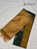 Kadamparii Silk emerald green semi soft silk saree with antique gold zari border, floral woven motifs, rich zari pallu, and elegant tassel detailing.