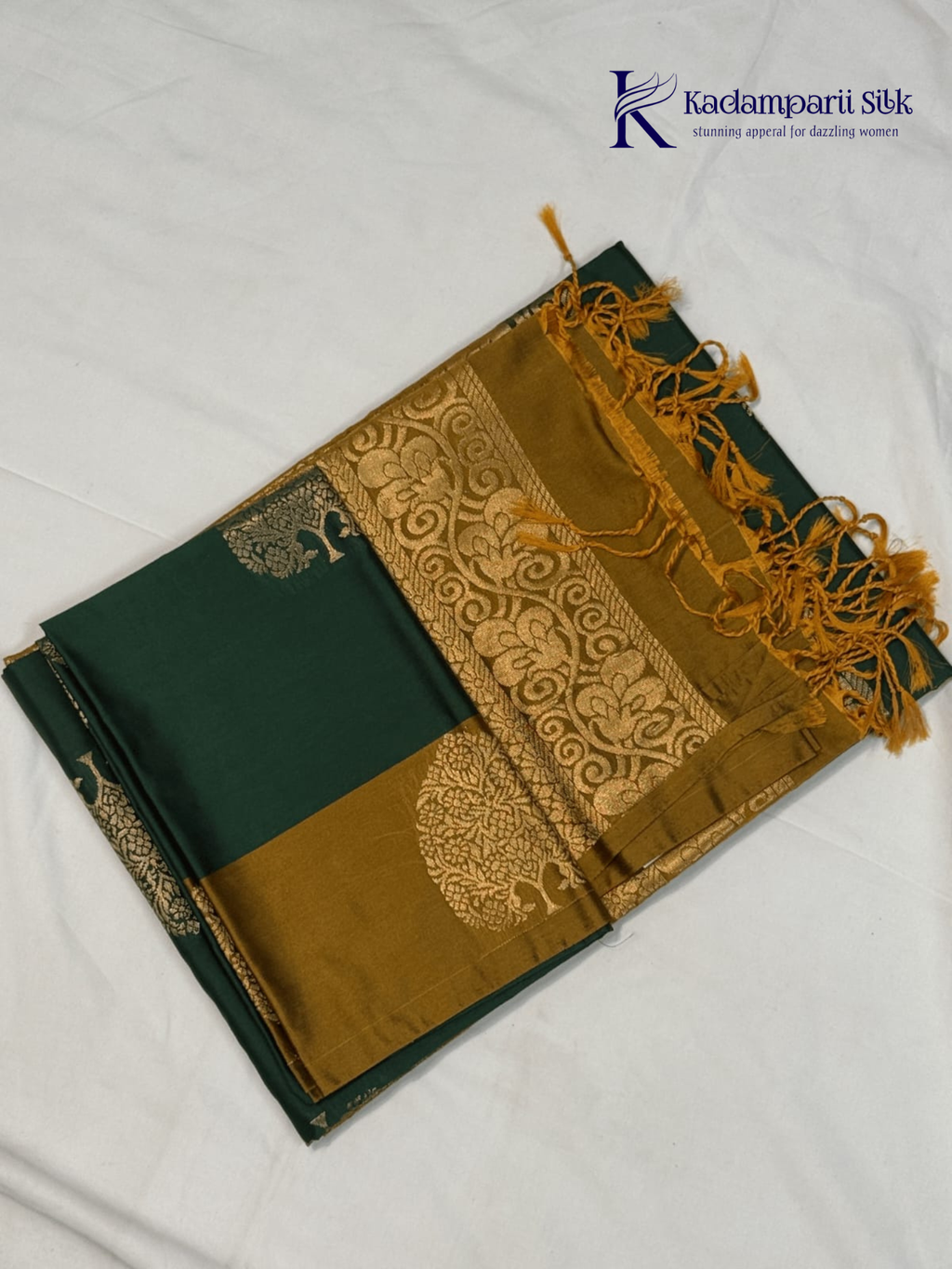 Kadamparii Silk emerald green semi soft silk saree with antique gold zari border, floral woven motifs, rich zari pallu, and elegant tassel detailing.