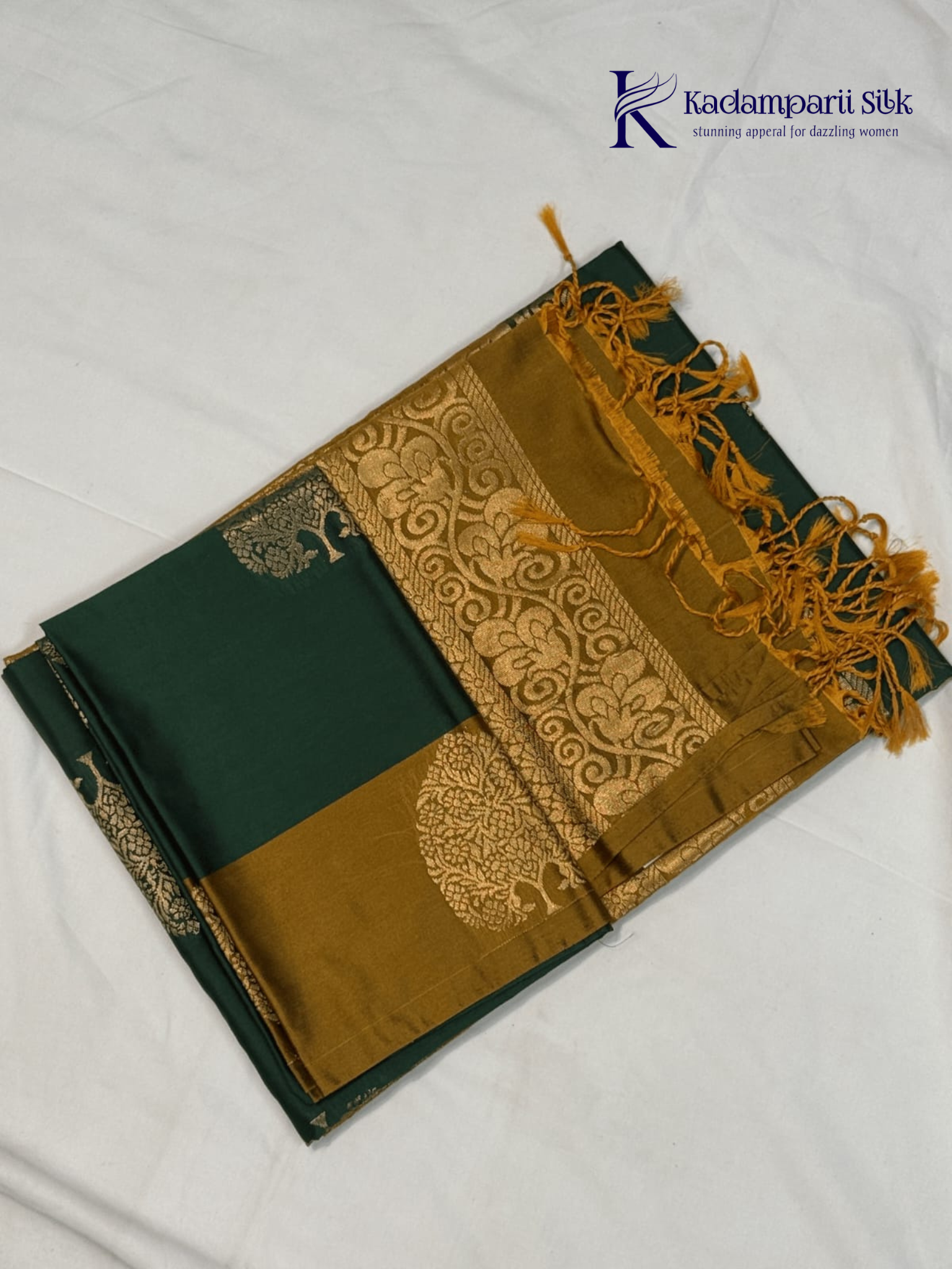 Kadamparii Silk emerald green semi soft silk saree with antique gold zari border, floral woven motifs, rich zari pallu, and elegant tassel detailing.