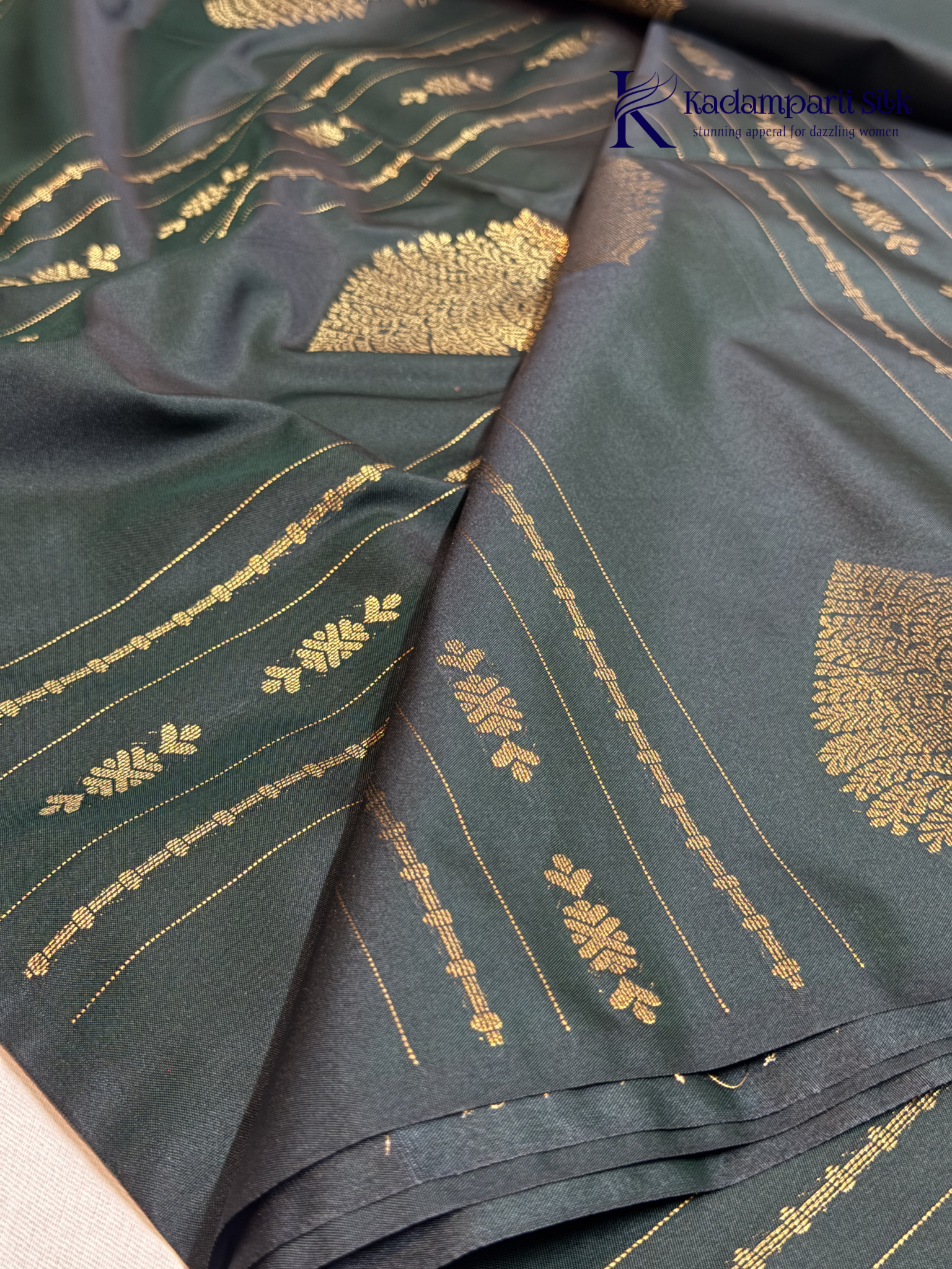 Kadamparii Silk royal navy blue semi soft silk saree with gold zari motifs, paisley design, grand zari woven pallu, and tassel detailing.